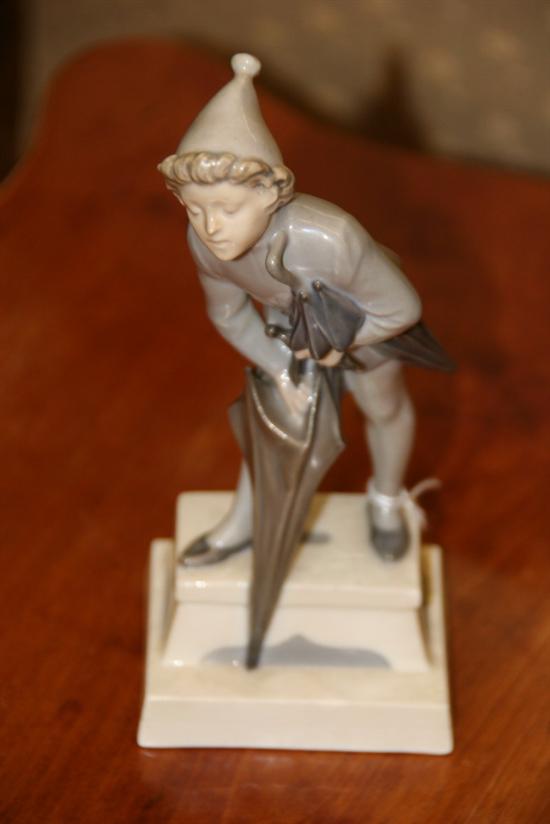 ROYAL COPENHAGEN FIGURE OF A BOY WITH UMBRELLAS. - 7 in. high.
